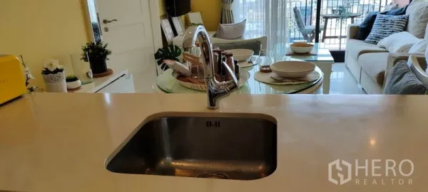 Condominium for rent or sale in Khlong Toei, Bangkok - Kitchen sink island facing the dining area and bright living room.