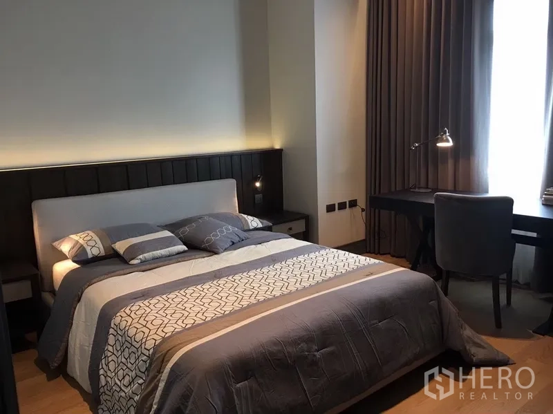 公寓 出租在Watthana, Bangkok - 次卧配双人床、床头柜、书桌与遮光窗帘。