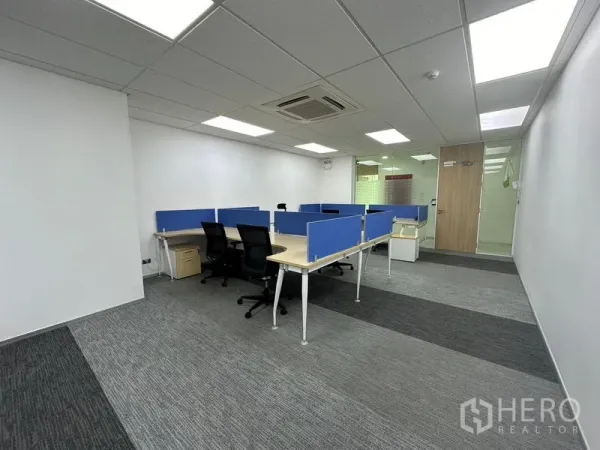 Office Space for rent - Fitted office space with desk clusters, swivel chairs, and a glass-partitioned entry and meeting area.