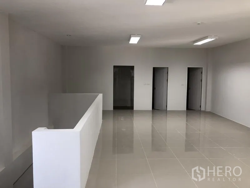 Factory for rent in Samut Prakan - Second-floor office space with glossy tiles and multiple rooms.