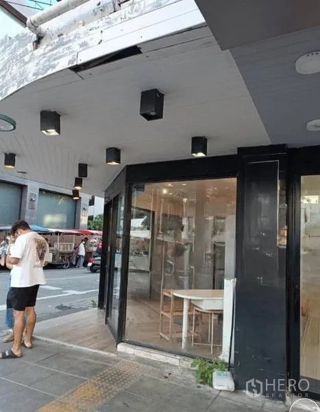 Retail Space for rent in Watthana, Bangkok - Side view of renovated shopfront with spotlighted canopy and clear glass entrance.