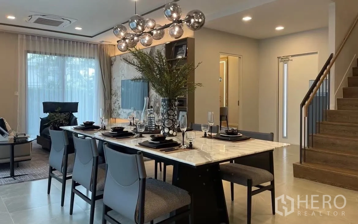 Detached House for rent in Bang Phli, Samut Prakan - Dining table view toward staircase and living area.
