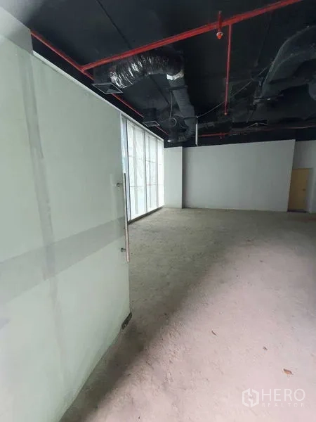 Retail Space for rent in Bang Rak, Bangkok - Unfitted retail unit with glass entrance, concrete floor, and exposed ceiling ducts.