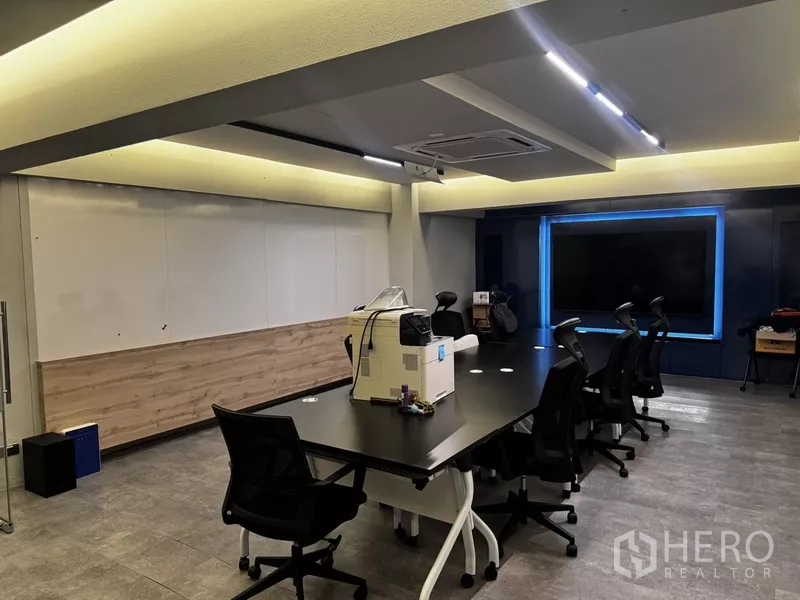 Office Space for rent or sale in Suan Luang, Bangkok - Modern meeting room with large screen, accent lighting and conference table.