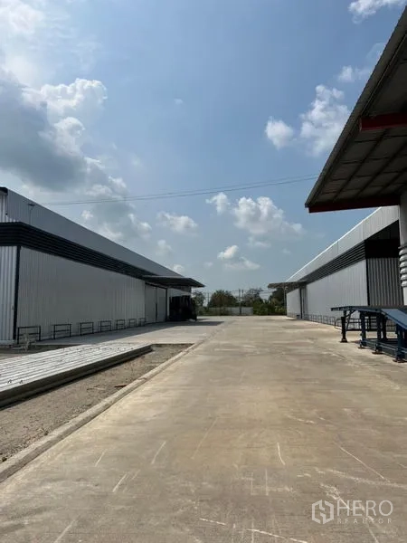 คลังสินค้า ให้เช่าในPathum Thani - ทางสัญจรระหว่างโกดังผนังเมทัลชีทสองฝั่ง รถบรรทุกเข้าออกสะดวก