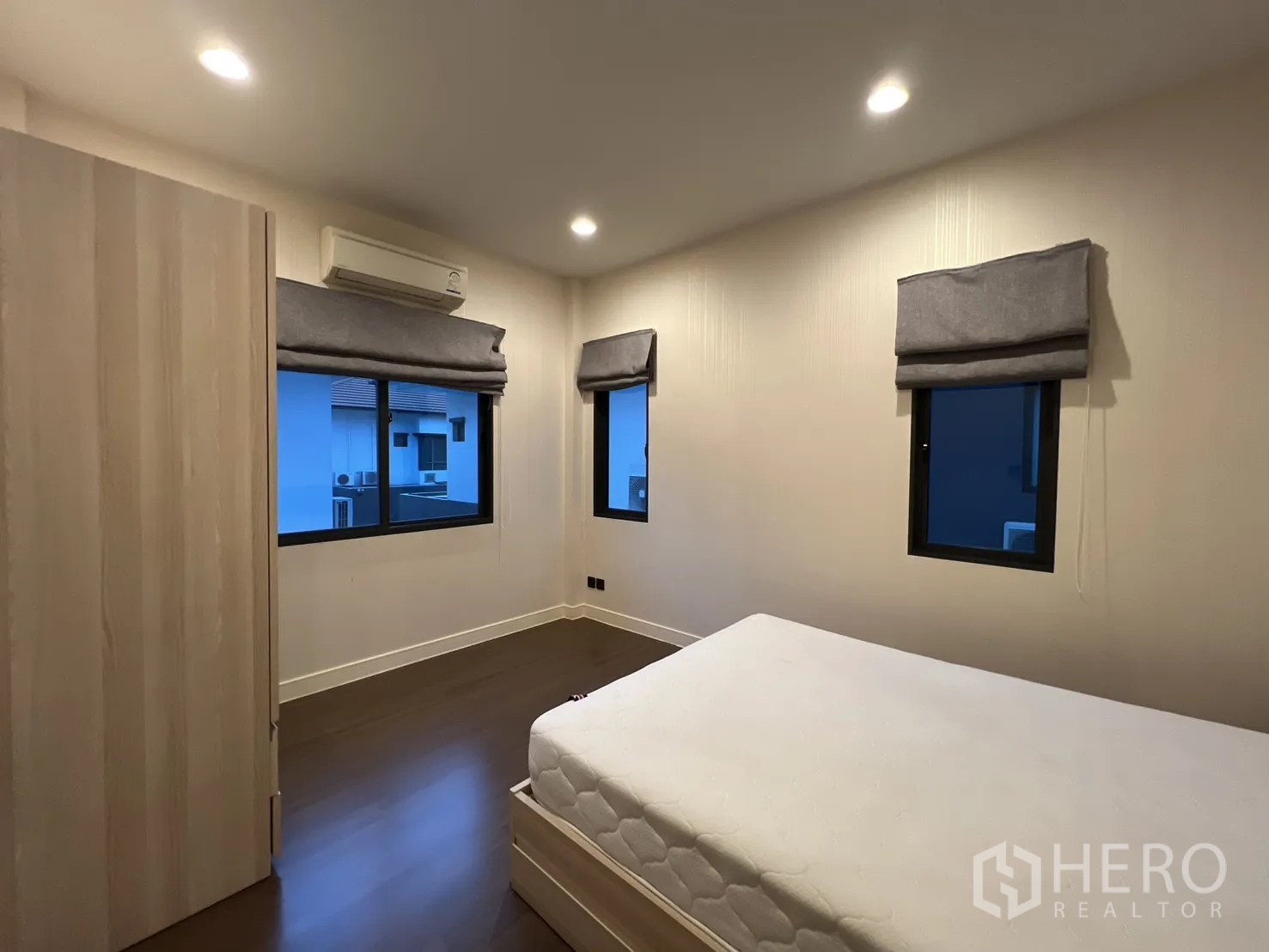 Detached House for rent or sale in Bang Kapi, Bangkok - Guest bedroom angle showing bed and blinds.