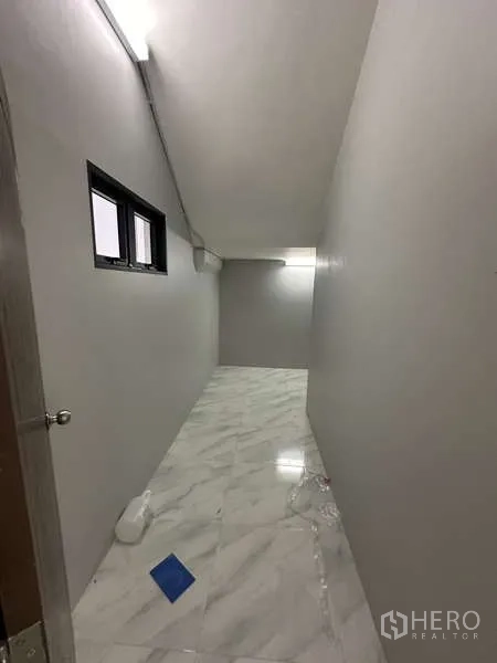 工厂 出租或出售在Lam Luk Ka, Pathum Thani - 狭长的功能走廊，大理石纹地砖与小窗。