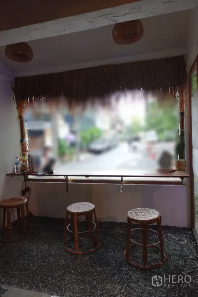 Retail Space for rent in Khlong Toei, Bangkok - Window bar seating with woven stools overlooking the street from the shopfront.