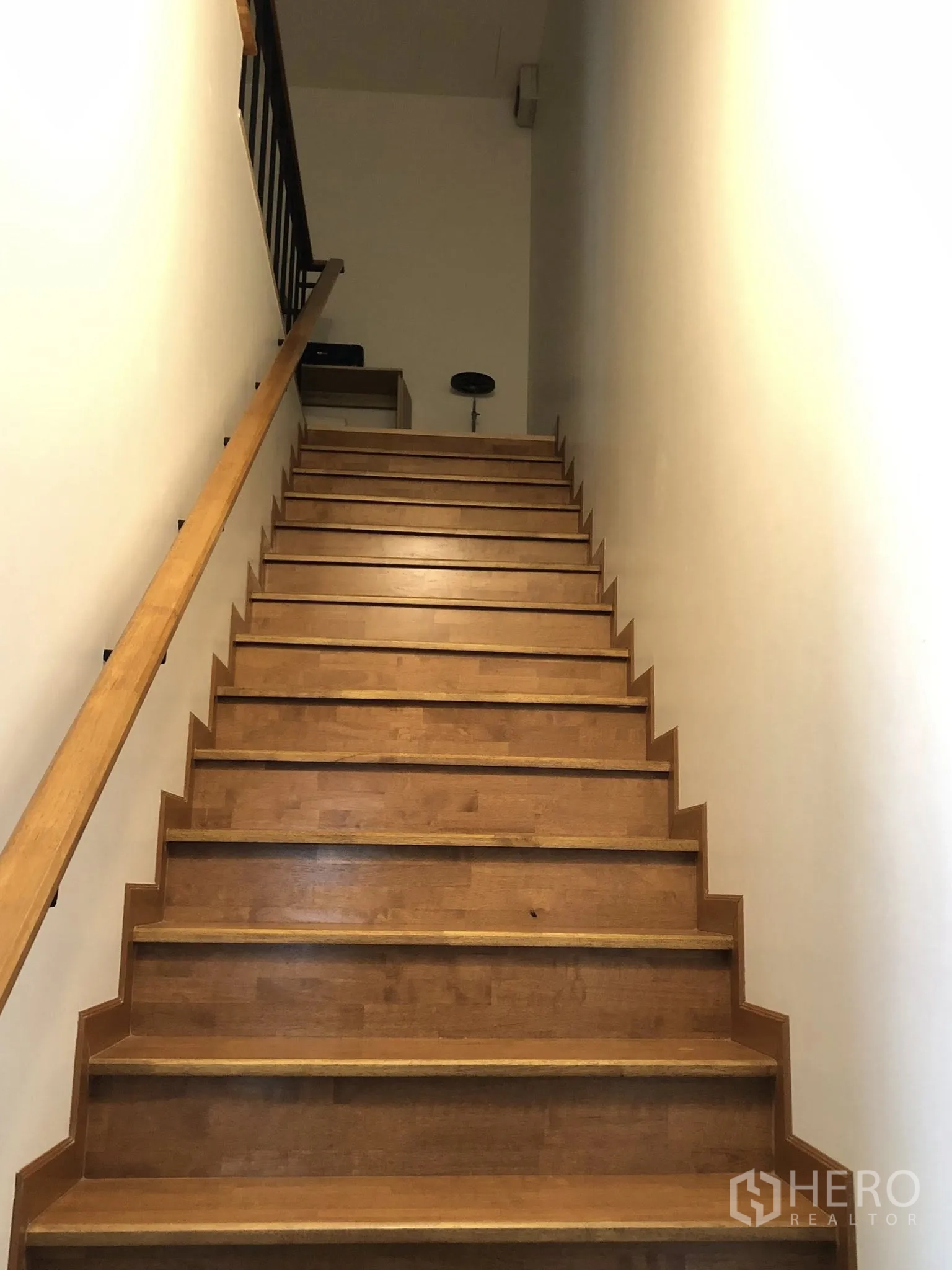 Townhouse for sale in Phra Khanong, Bangkok - Wide wooden staircase with handrail leading to the upper levels.