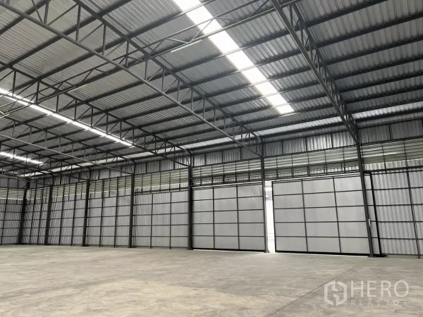 货栈 出租在Lat Lum Kaeo, Pathum Thani - 仓库内多樘推拉装卸门与钢结构屋顶，采光良好