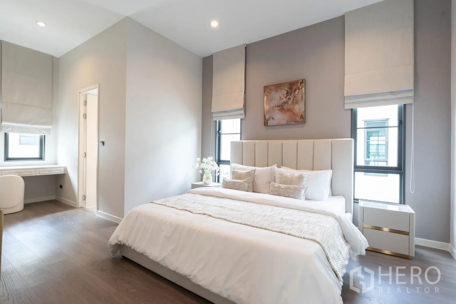 Detached House for rent in Bang Phli, Samut Prakan - Bedroom with upholstered headboard, two tall windows, and ensuite entry.