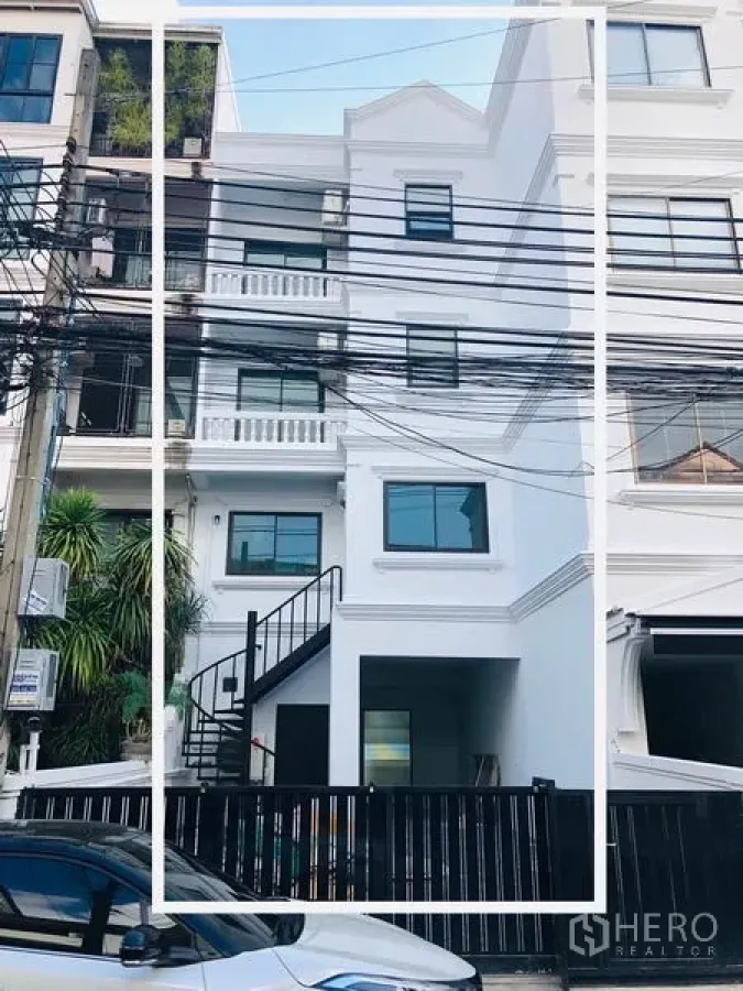 带办公室的家 出租在Khlong Toei, Bangkok - 四层白色住办公楼外立面，带阳台、黑色大门与外部楼梯，临街排屋。