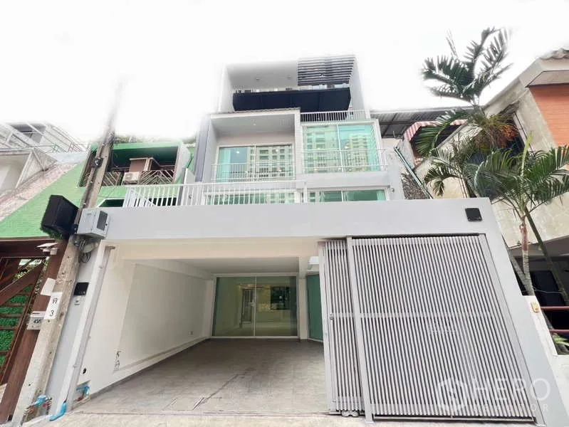 带办公室的家 出租在Khlong Toei, Bangkok - 纳那区现代多层住办楼外立面，带电动大门车位与阳台。