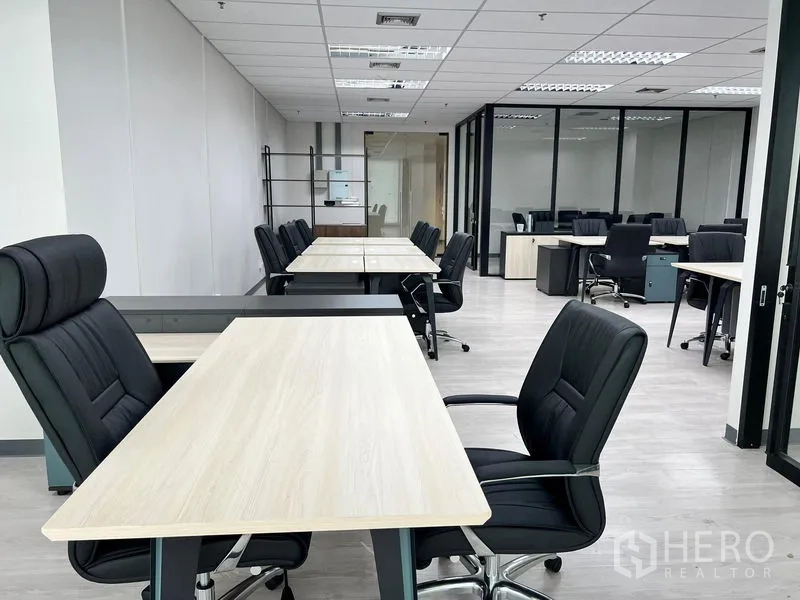 Office Space for rent in Sathon, Bangkok - Perspective view of workstation rows in a bright, minimalist office interior.