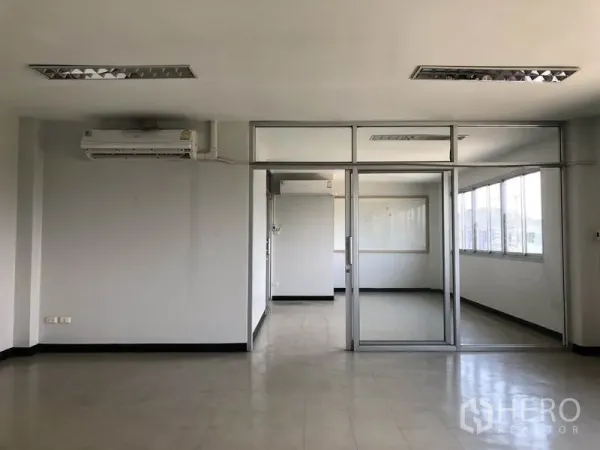 Factory for rent in Pathum Thani - Interior office with glass partitions, windows and air conditioning.