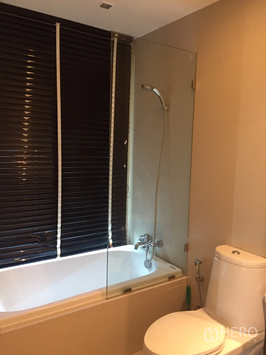 Condominium for rent in Watthana, Bangkok - Second bathroom with bathtub, shower over tub, toilet and glass partition.