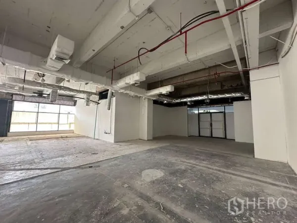 Office Space for rent - Spacious unfinished office with concrete floors, ducted air system and glazed frontage.