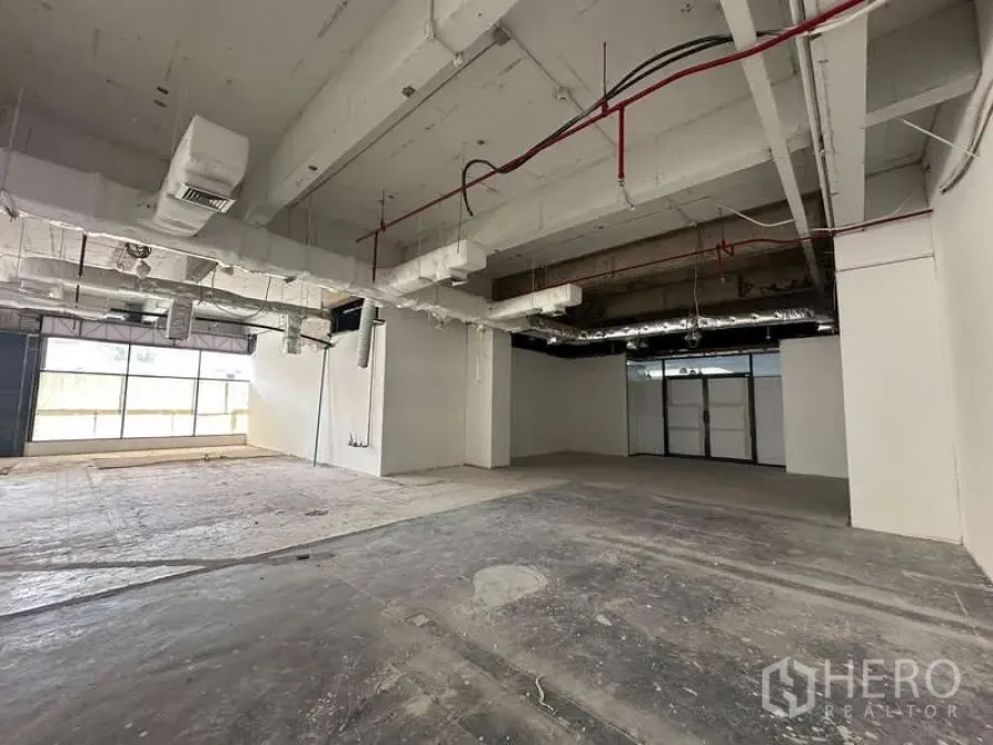 Office Space for rent - Spacious unfinished office with concrete floors, ducted air system and glazed frontage.