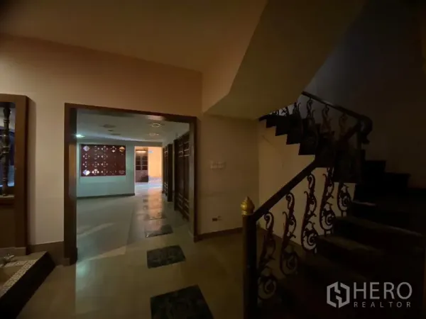 Retail Space for rent in Watthana, Bangkok - Staircase with wrought-iron railing beside an open retail hall.