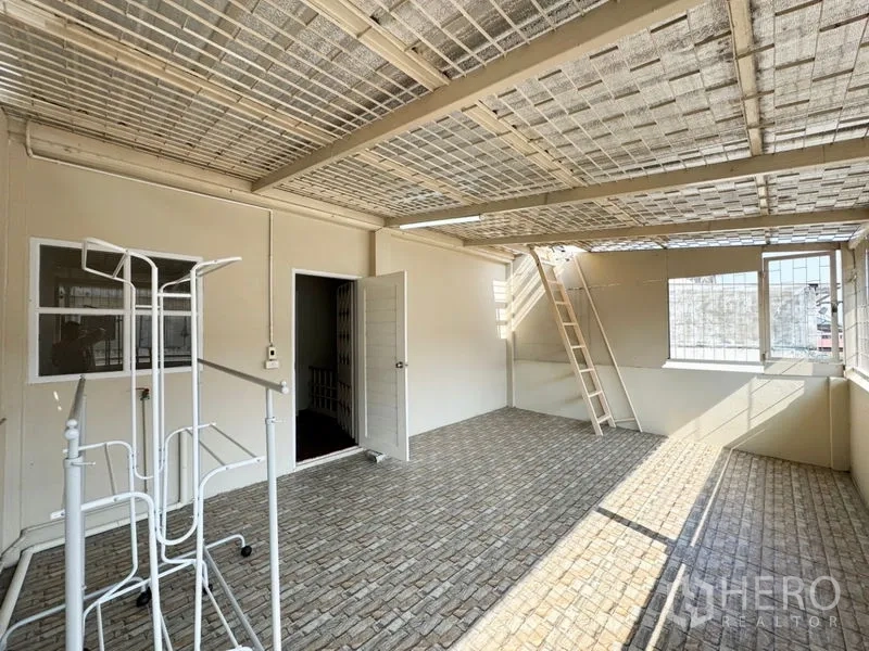 Townhouse for rent or sale in Suan Luang, Bangkok - Covered rooftop terrace or laundry area with tiled floor and ladder