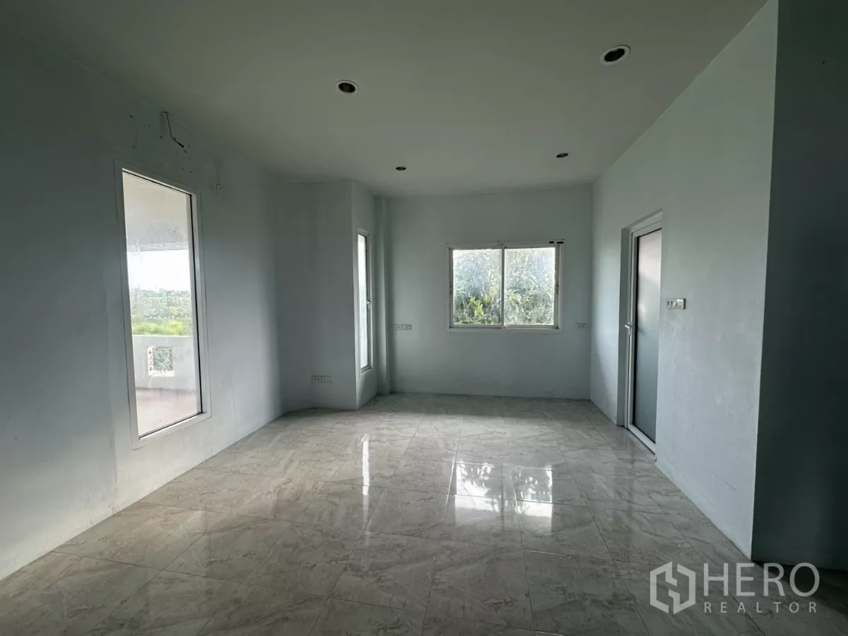 Home Office for rent - Upper hallway with stainless railing, wooden doors and balcony access.