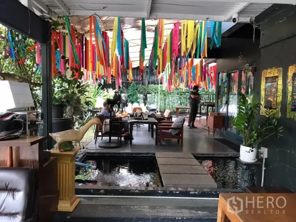 Retail Space for rent in Watthana, Bangkok - Open-air seating beside a reflecting pond with ribbons hanging overhead.