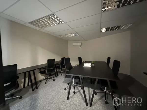 Office Space for rent in Bang Rak, Bangkok - Open-plan workspace with long desks, task chairs, carpet tiles, and air conditioning.