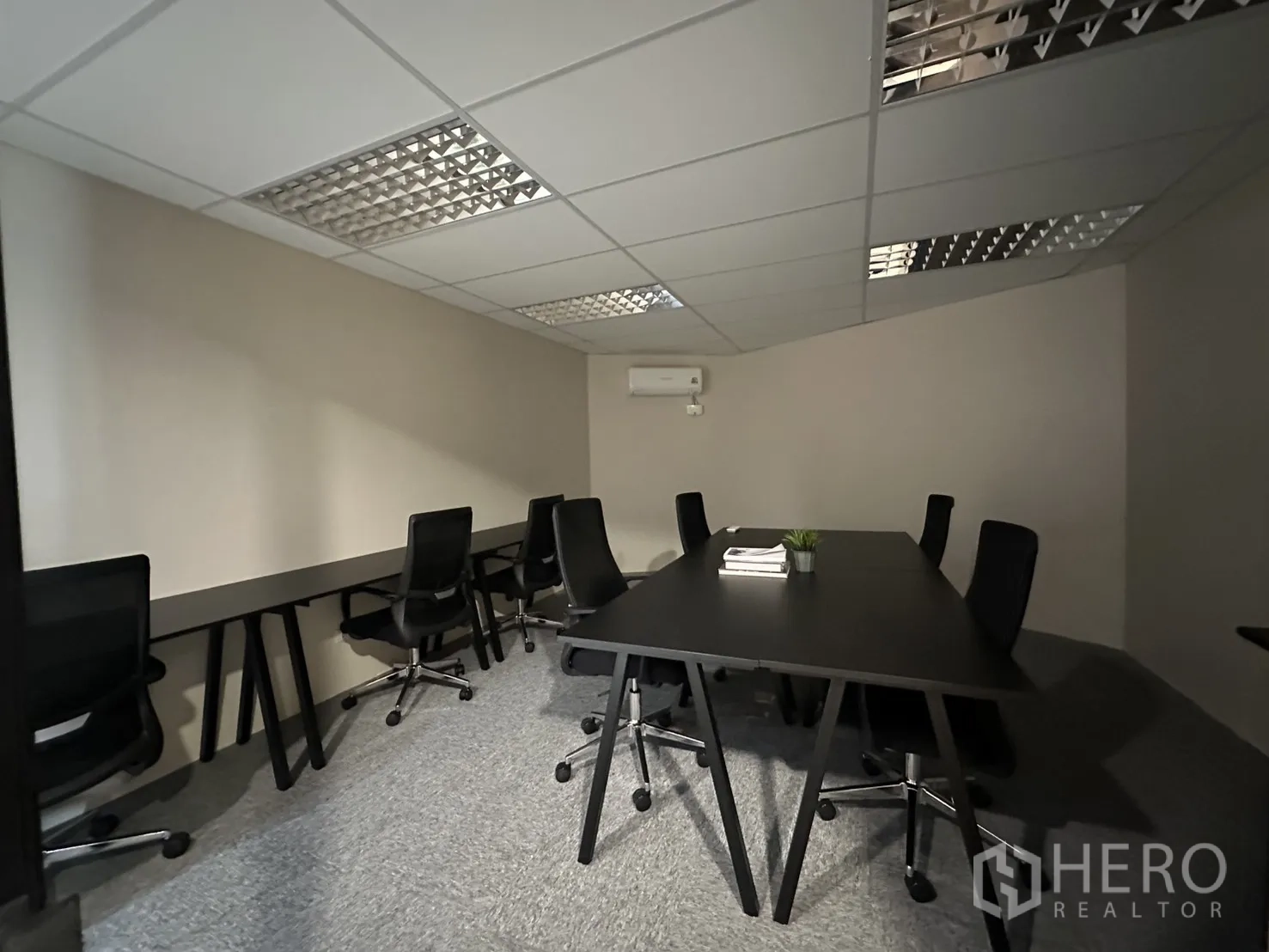 Office Space for rent in Bang Rak, Bangkok - Open-plan workspace with long desks, task chairs, carpet tiles, and air conditioning.