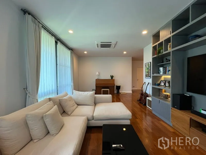 Detached House for rent in Bang Kapi, Bangkok - Living area facing the piano and large windows with sheer curtains.