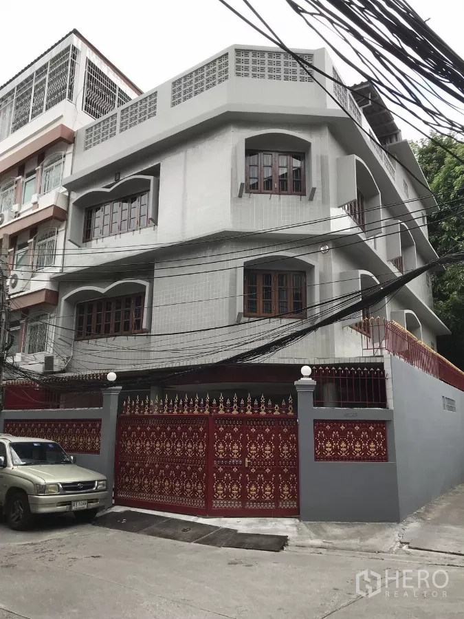 Home Office for rent in Dusit, Bangkok - Facade close-up of the multi-storey building with tiled exterior walls and wooden-framed windows.