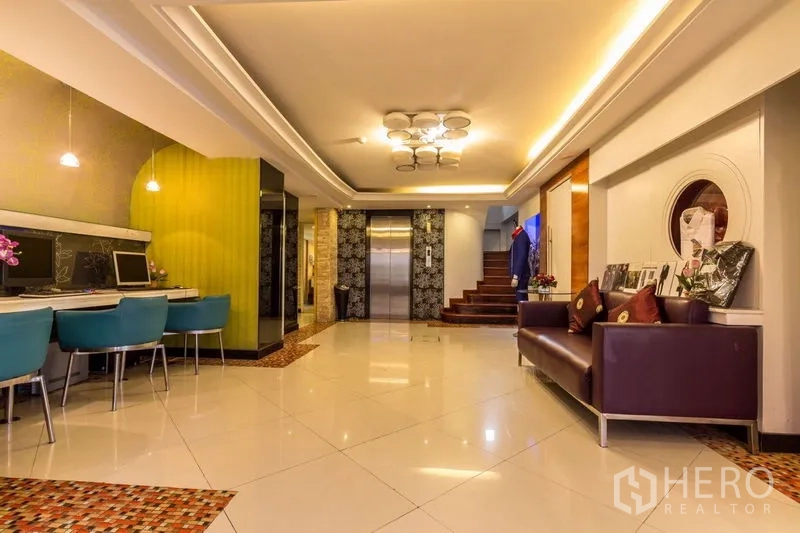 Retail Space for rent - Bright lobby area featuring elevators, seating and computer desks for customers.