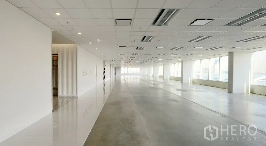 Office Space for rent in Khlong Toei, Bangkok - Bright open-plan office floor with large windows, grid ceiling with LED lights and AC vents, and polished floors.