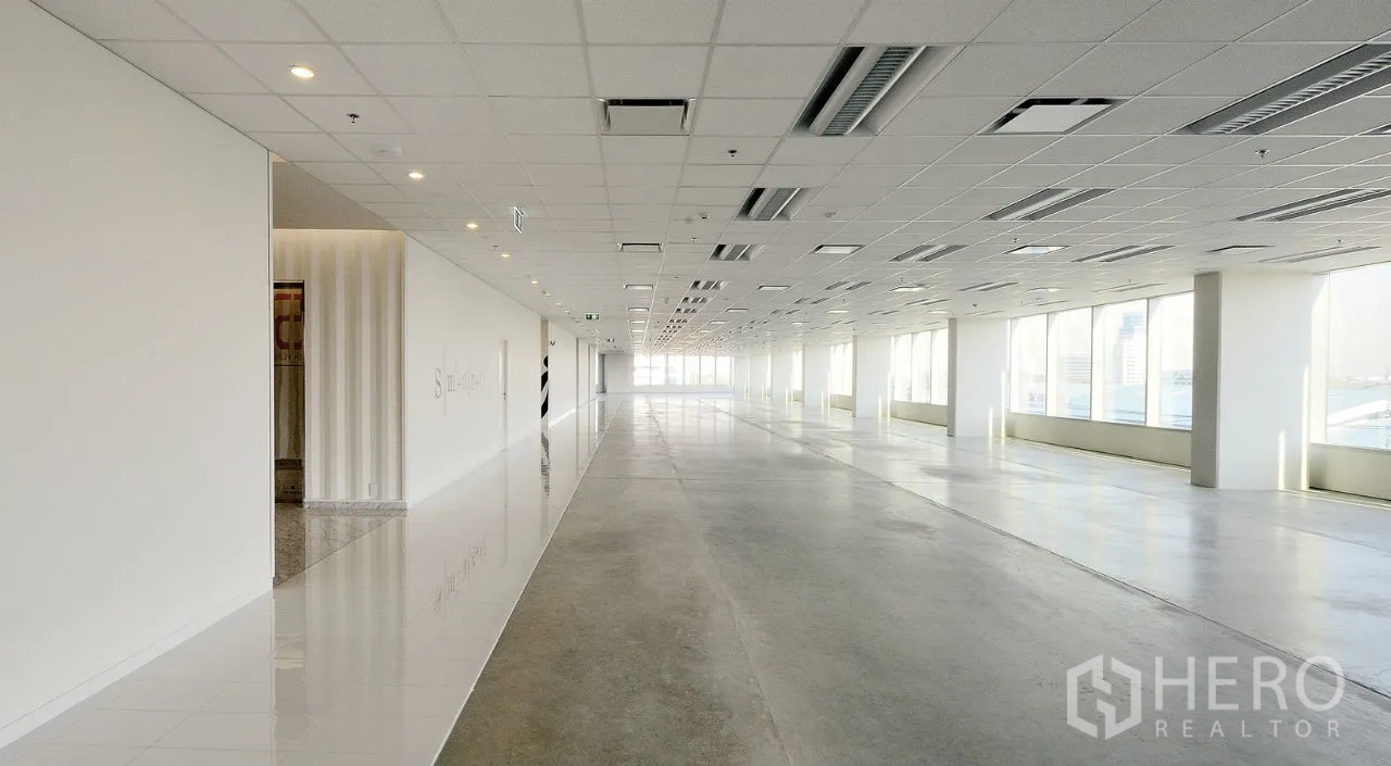 Office Space for rent in Khlong Toei, Bangkok - Bright open-plan office floor with large windows, grid ceiling with LED lights and AC vents, and polished floors.