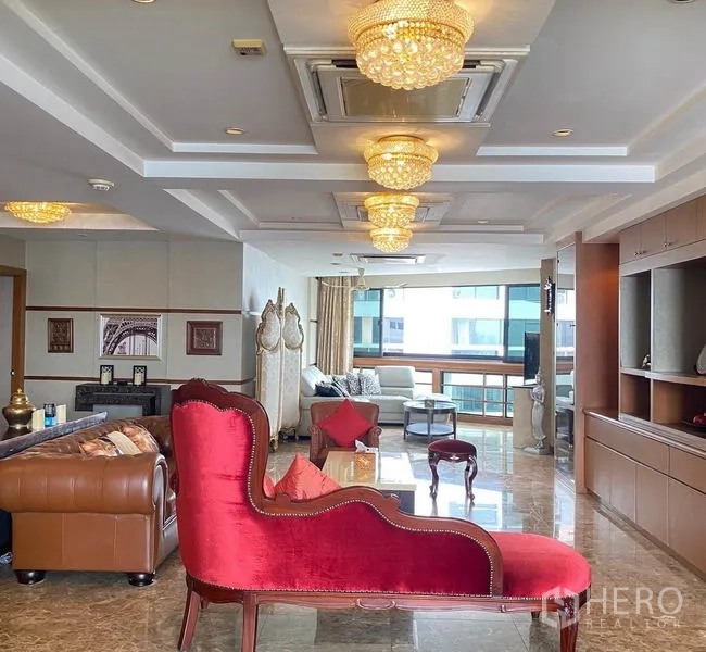Condominium for rent in Khlong Toei, Bangkok - Long open-plan living and entertaining space illuminated by crystal chandeliers.