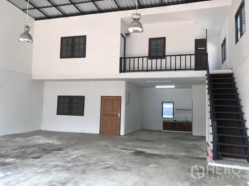 货栈 出租在Pathum Thani - 宽幅室内视角，展示夹层办公室、楼梯与挑高空间。