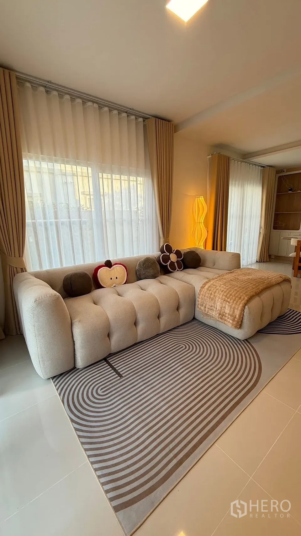 Detached House for rent in Bang Phli, Samut Prakan - Corner sofa by full-height curtains and a modern sculptural floor lamp.