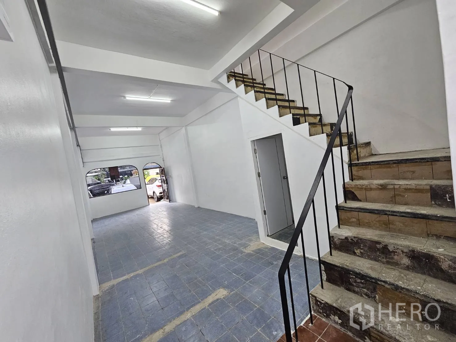Home Office for rent in Khlong Toei, Bangkok - Front windows and entrance on the ground floor with a staircase leading up.
