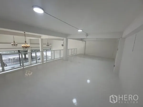 Retail Space for rent in Khlong Toei, Bangkok - Mezzanine level overlooking the shopfront with bright white floors and railings.