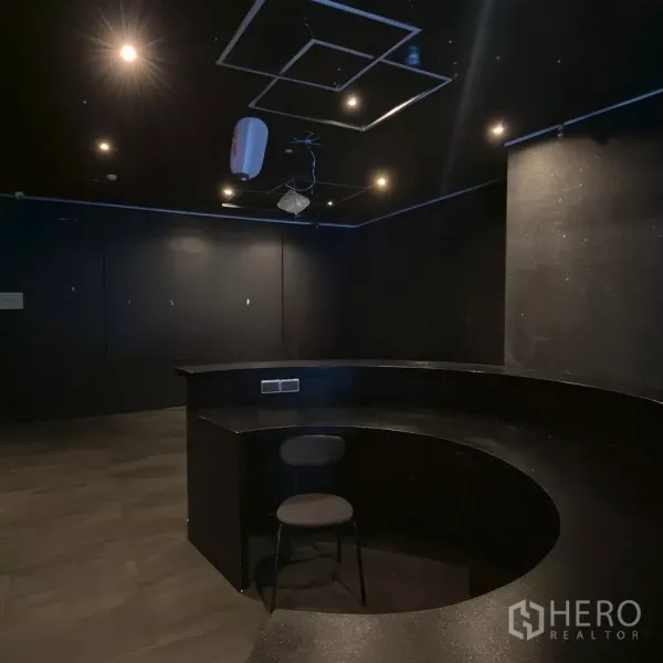 Retail Space for rent - Enclosed room with a built-in semicircular counter and downlights, suitable for back office or bar.