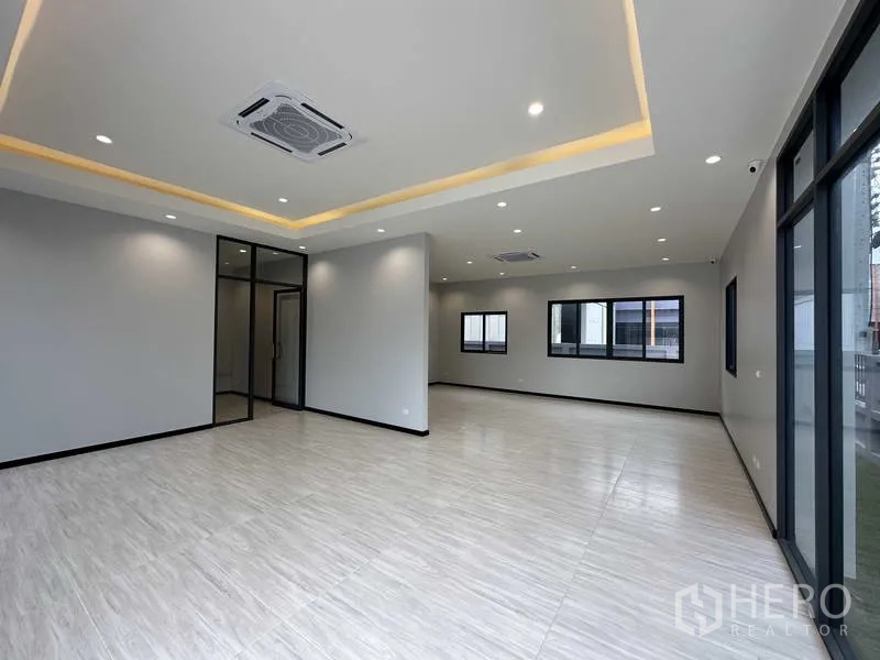 Factory for rent or sale in Lam Luk Ka, Pathum Thani - Modern office area with glass partitions, drop-ceiling lighting and ample daylight.