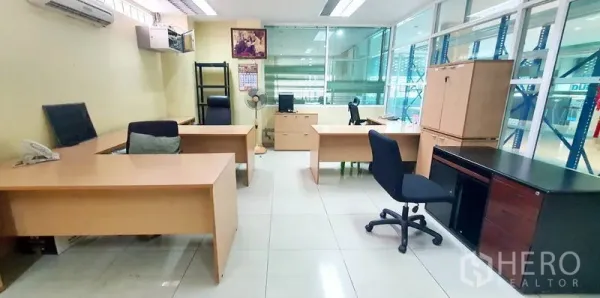 Office Space for rent in Bang Kho Laem, Bangkok - Shared office facing a glass-partitioned wall with desks, chairs and cabinets.