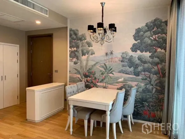 Condominium for sale in Watthana, Bangkok - Elegant dining space with mural feature wall and soft natural light filtering through drapes.
