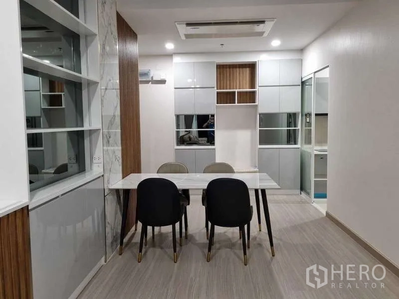 Condominium for rent - Front view of the dining space with built-in cabinetry and modern lighting.