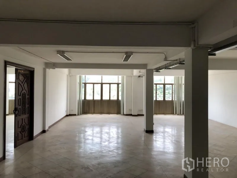 Office Space for rent in Huai Khwang, Bangkok - Flexible office area with decorative wooden door and windows.