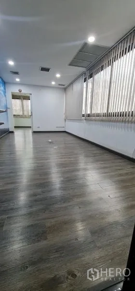 办公空间 出租在Watthana, Bangkok - 狭长房间，一排窗户、竖百叶与木纹地板。