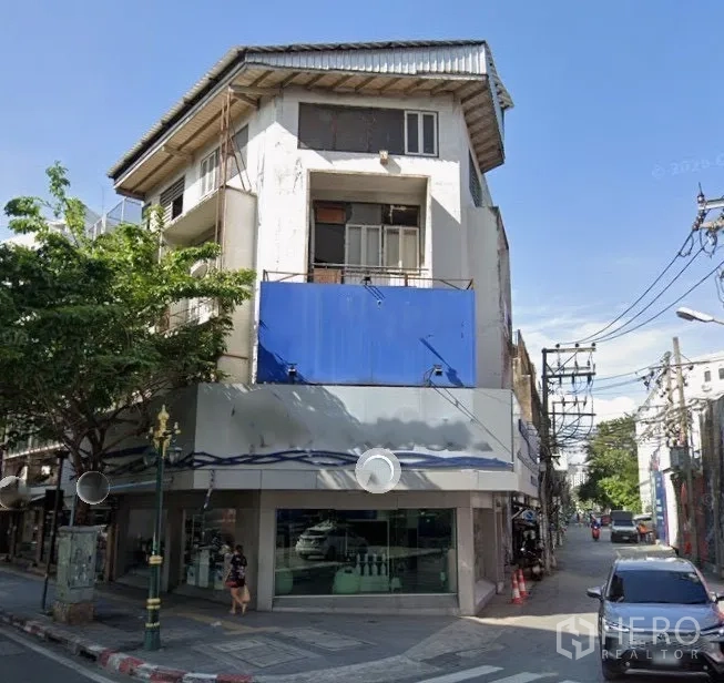 店屋 for rent in Watthana, Bangkok - 街角转角商铺外观，配有大面积橱窗与招牌位置。