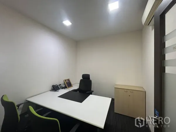 Office Space for rent - Compact executive office with desk, chairs, storage cabinet and air-conditioning unit.