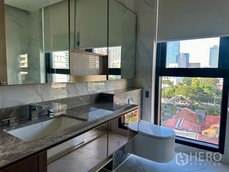 Condominium for rent - Modern bathroom vanity with marble countertop, large mirror cabinets and city view.