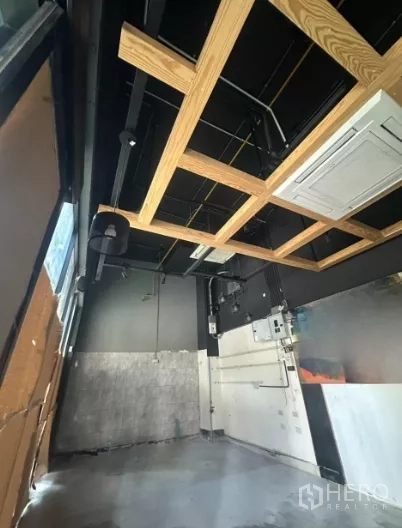 Retail Space for rent - Close-up of the wood ceiling grid with AC cassette and industrial lighting tracks.