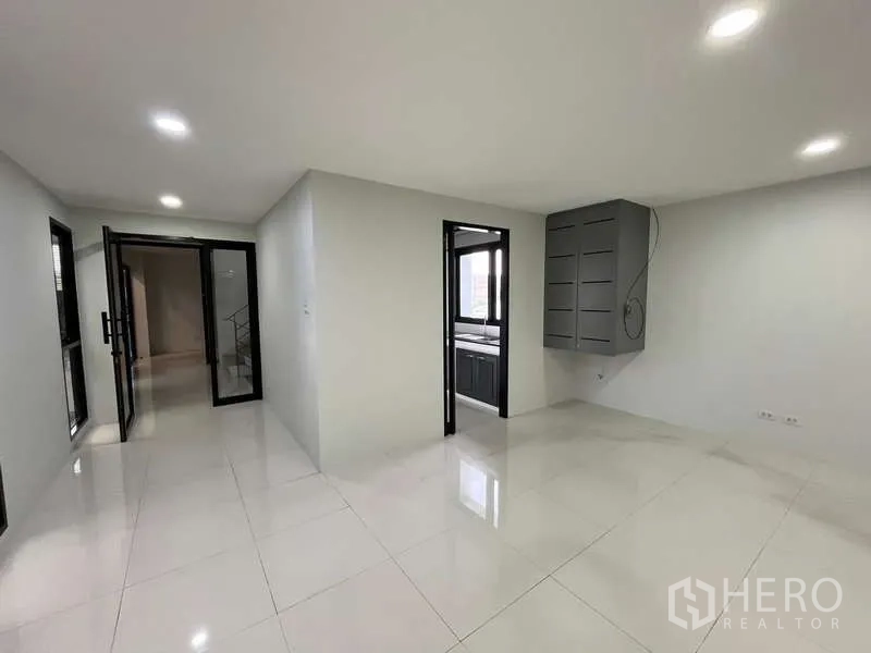Office Space for rent in Prawet, Bangkok - Office corridor with glass entry, wall-mounted network cabinet and doorway to pantry.
